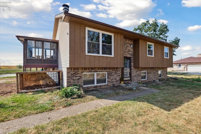 view of front facade featuring a front yard and a sunroom