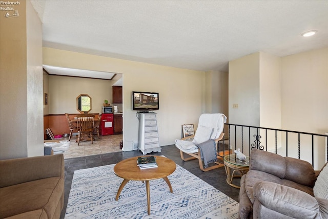 tiled living room featuring a textured ceiling