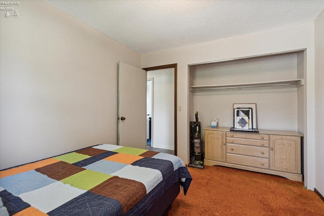 bedroom with carpet floors, a textured ceiling, and a closet