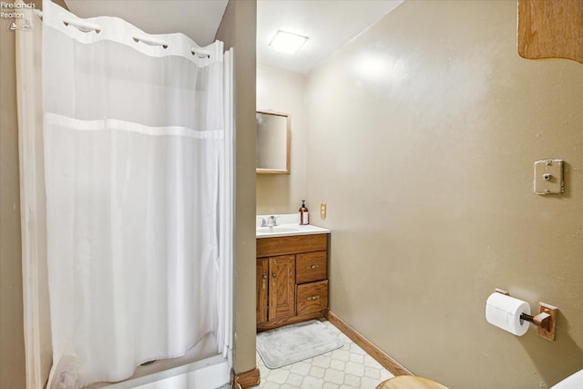 bathroom featuring walk in shower and vanity