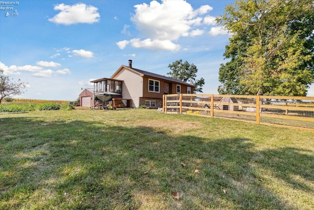 view of yard featuring a wooden deck and a rural view