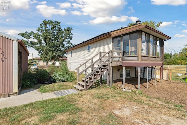 rear view of house with a sunroom