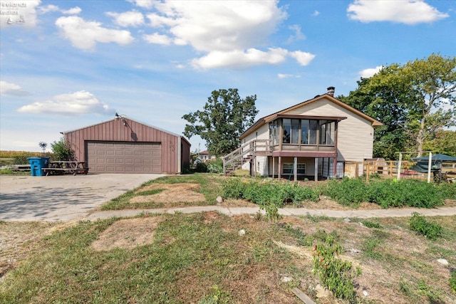 view of front facade featuring an outbuilding and a garage