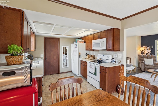 kitchen with light tile patterned floors, ornamental molding, white appliances, and decorative backsplash