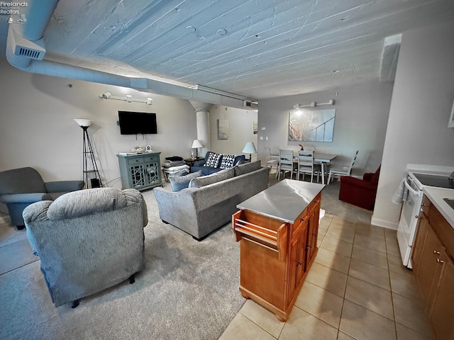 living room with wood ceiling and light tile patterned floors