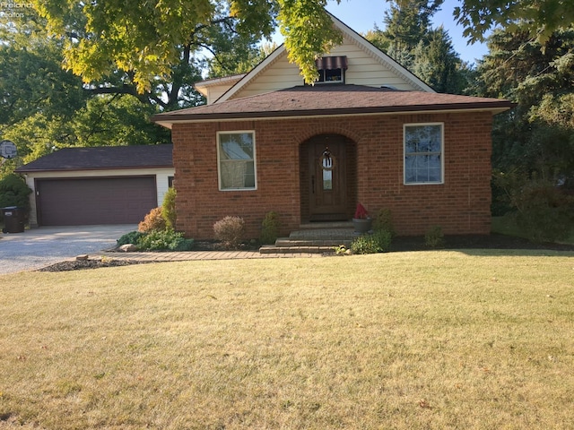 view of front of home with a garage and a front lawn