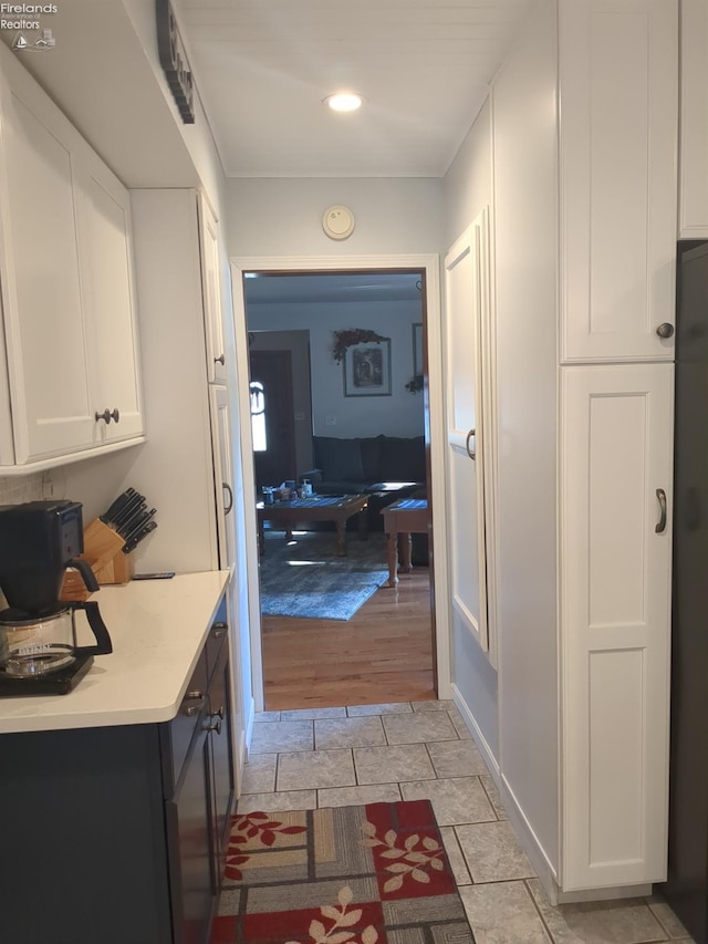 corridor with light tile patterned floors