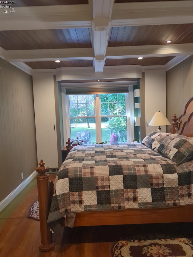 bedroom featuring hardwood / wood-style flooring, beam ceiling, wooden walls, and coffered ceiling