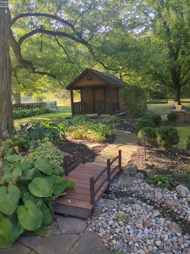 wooden terrace featuring an outbuilding