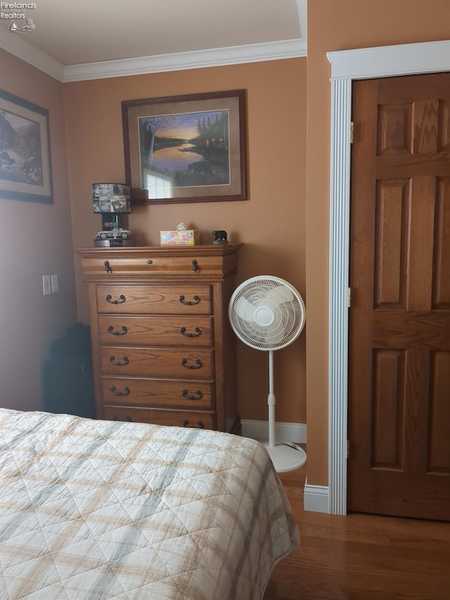 bedroom with light hardwood / wood-style flooring and ornamental molding