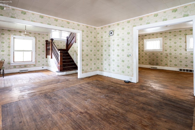 spare room with hardwood / wood-style floors and plenty of natural light