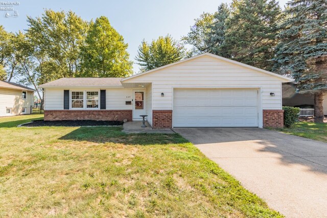 ranch-style house with cooling unit, a front lawn, and a garage