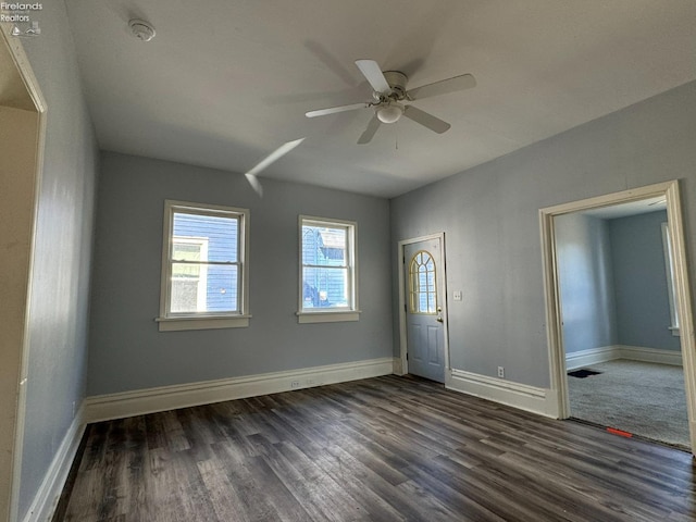 spare room with ceiling fan and dark hardwood / wood-style floors