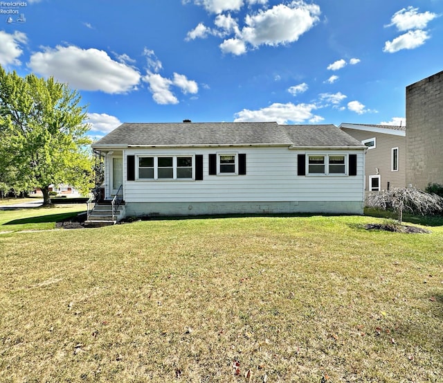 rear view of house featuring a yard