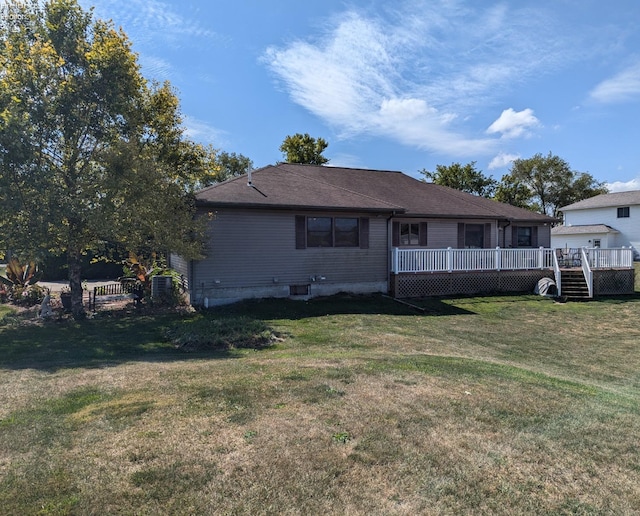 back of house featuring a yard and a wooden deck