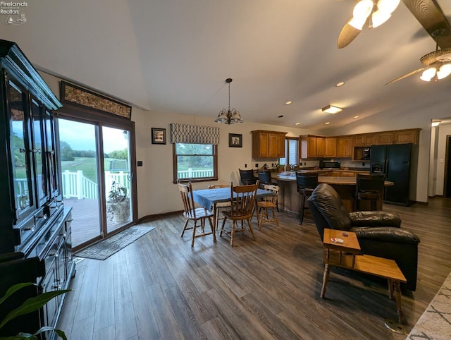 dining area featuring vaulted ceiling, ceiling fan, and hardwood / wood-style floors