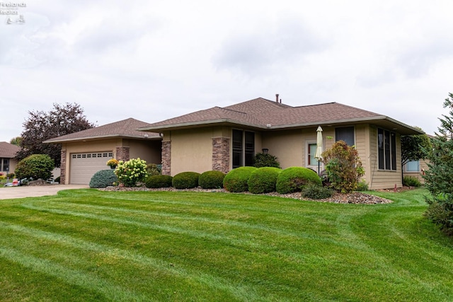 view of front of house with concrete driveway, stucco siding, stone siding, a front lawn, and a garage