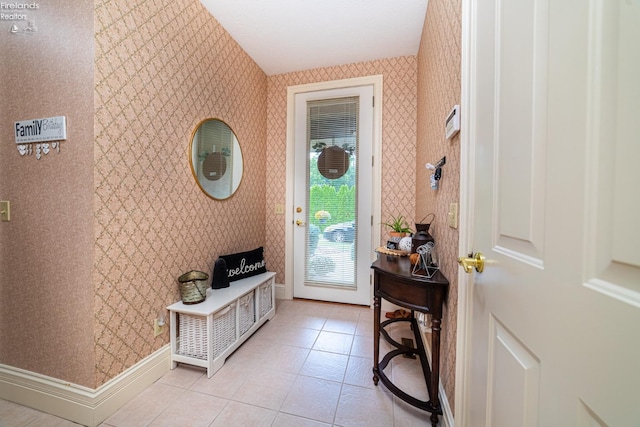 doorway with light tile patterned floors