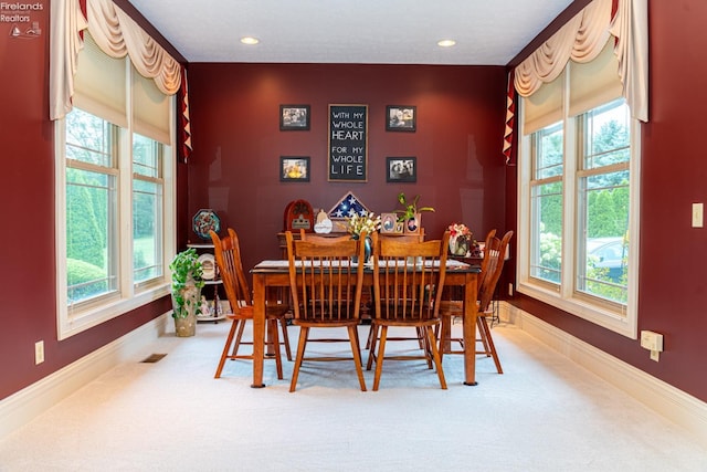 dining area with carpet flooring and a healthy amount of sunlight