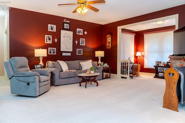 living room with ceiling fan and carpet