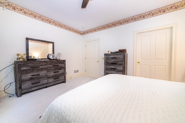 bedroom with ceiling fan and light colored carpet