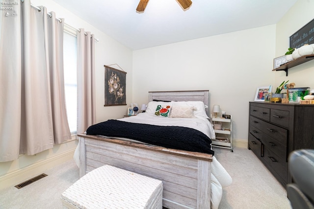 bedroom with ceiling fan and light carpet