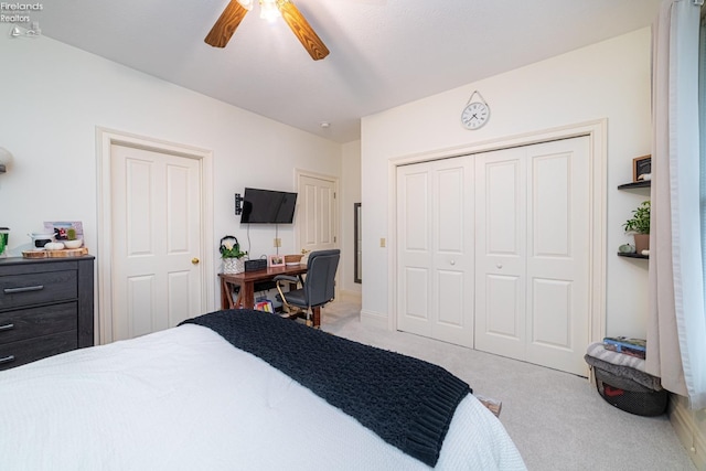 bedroom with a closet, ceiling fan, and light colored carpet