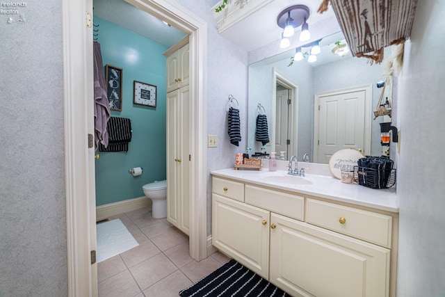 bathroom featuring vanity, toilet, and tile patterned floors