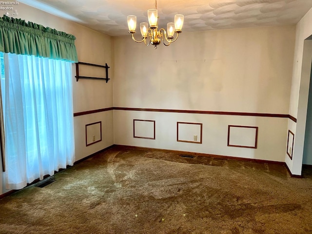 carpeted empty room featuring an inviting chandelier and plenty of natural light