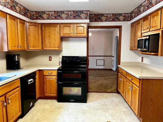 kitchen with light colored carpet and black appliances