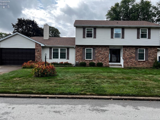 view of front facade with a garage and a front lawn