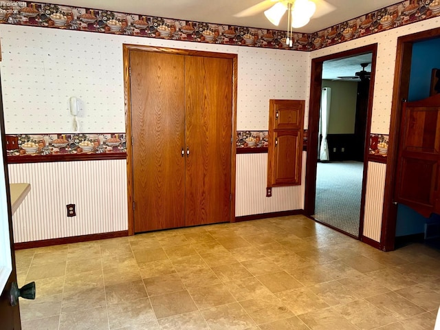 interior space featuring ceiling fan and a closet