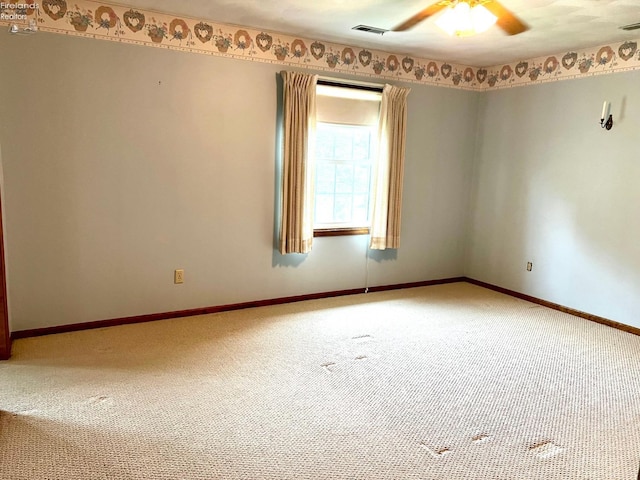 unfurnished room featuring ceiling fan and carpet floors