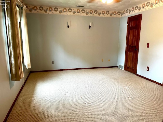 spare room with light colored carpet