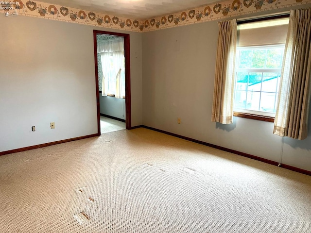 unfurnished room featuring light colored carpet