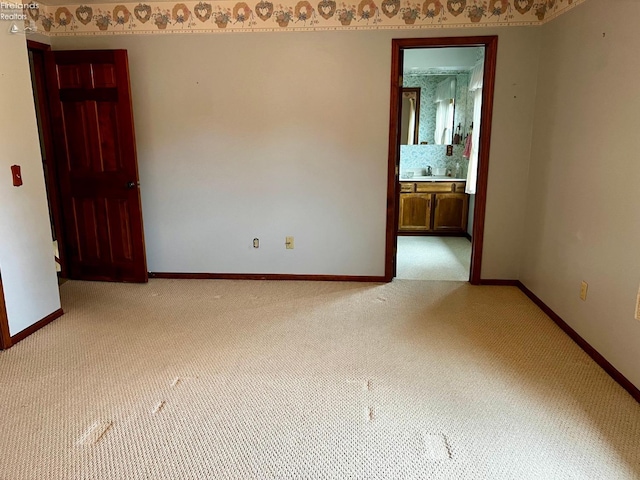 empty room with carpet floors and sink