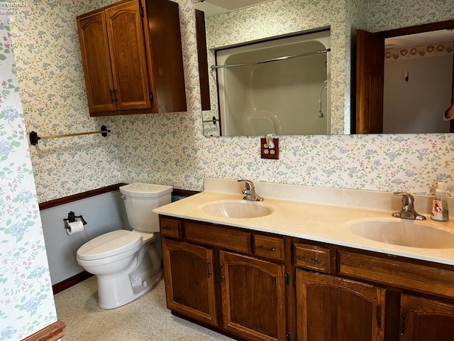 bathroom featuring curtained shower, vanity, and toilet