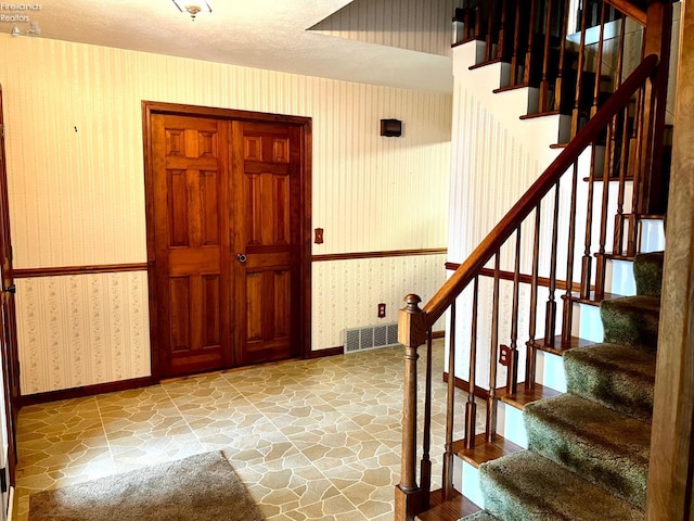 entryway with a textured ceiling