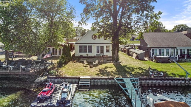 back of property featuring a yard and a water view