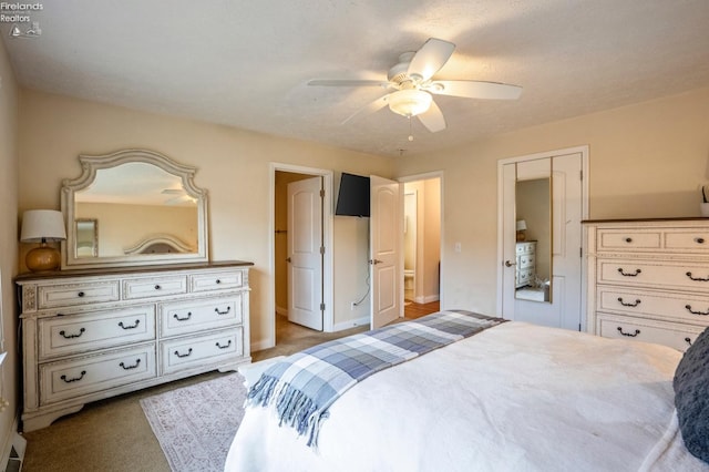 carpeted bedroom featuring a closet, ceiling fan, and a textured ceiling