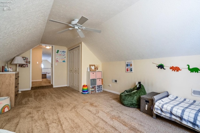 bedroom featuring carpet floors, vaulted ceiling, ceiling fan, and a closet