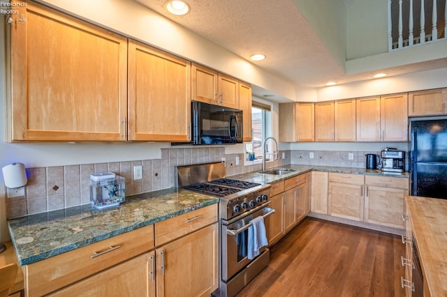 kitchen with sink, wooden counters, a textured ceiling, black appliances, and dark hardwood / wood-style floors