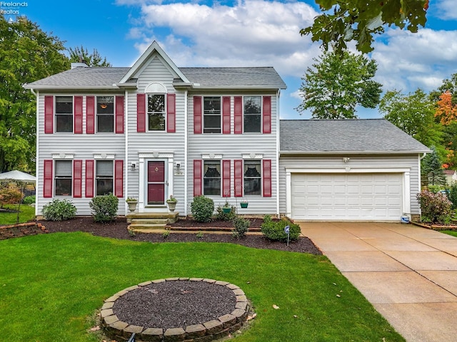 colonial-style house with a garage and a front lawn