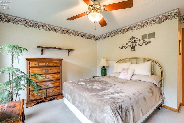 bedroom with ceiling fan and light carpet