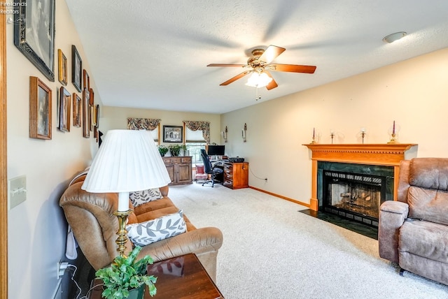 living room featuring a textured ceiling, carpet flooring, and ceiling fan