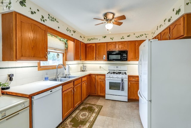 kitchen featuring decorative backsplash, white appliances, light tile patterned floors, ceiling fan, and sink