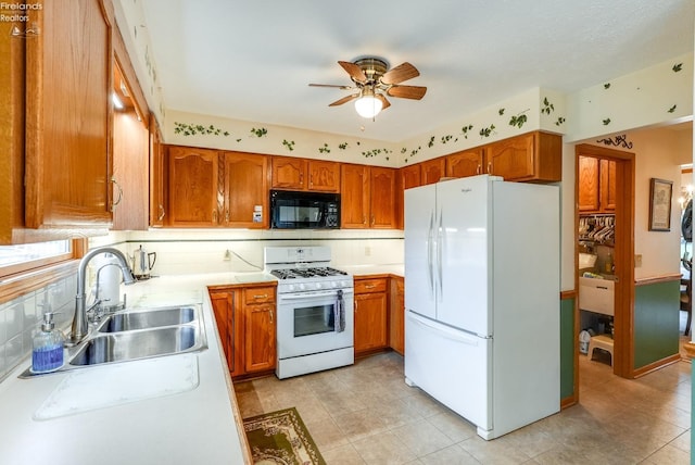 kitchen with ceiling fan, sink, white appliances, and decorative backsplash