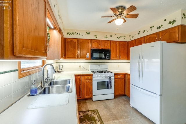 kitchen featuring white appliances, ceiling fan, tasteful backsplash, and sink