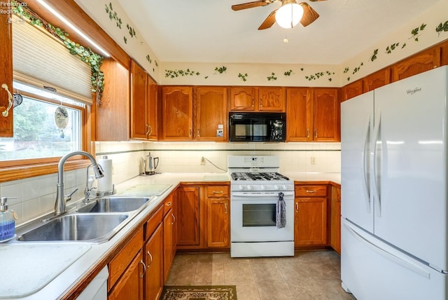 kitchen with sink, decorative backsplash, white appliances, light tile patterned floors, and ceiling fan