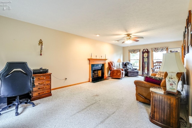 living room featuring ceiling fan, carpet flooring, and a textured ceiling